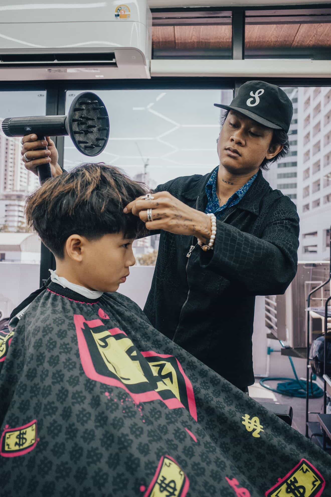 Men's fade haircut being done at a Bangkok barbershop