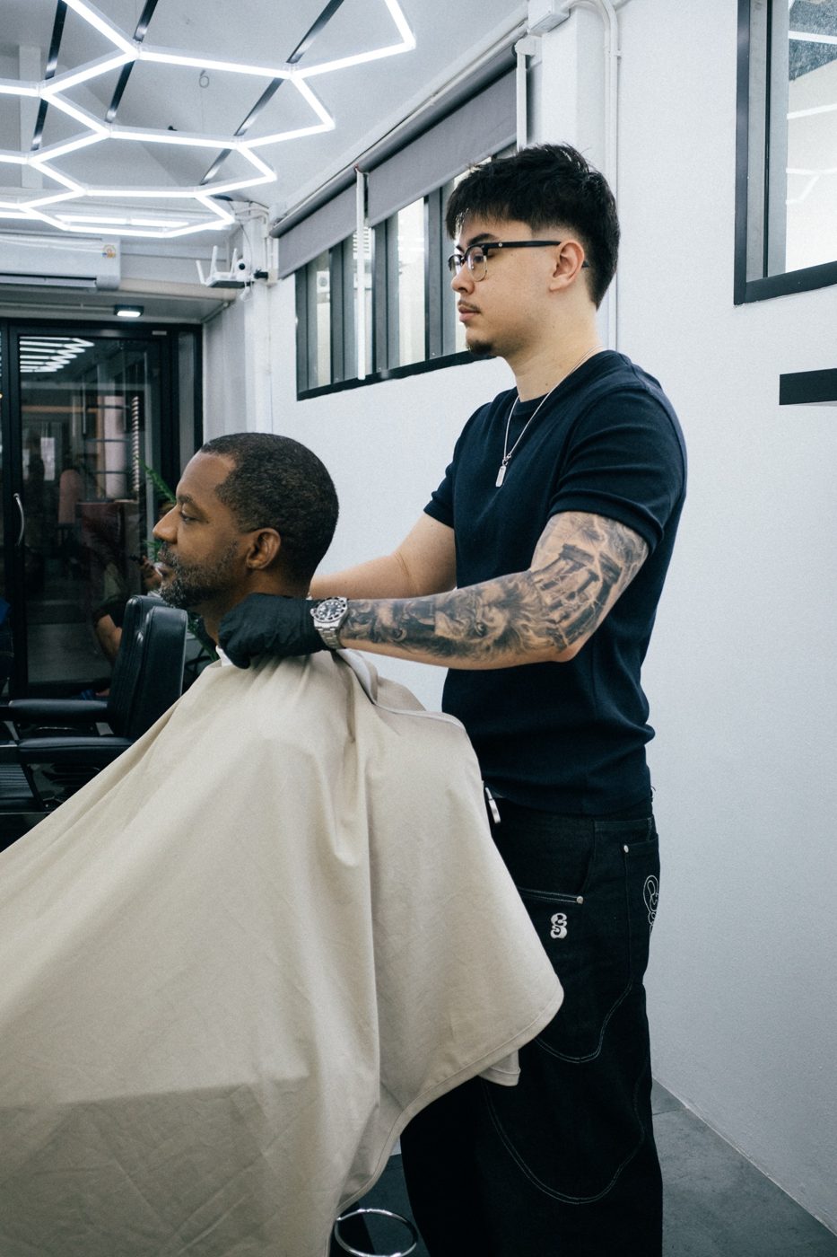 Leo — barber at Fijii Cuts Bangkok giving a haircut