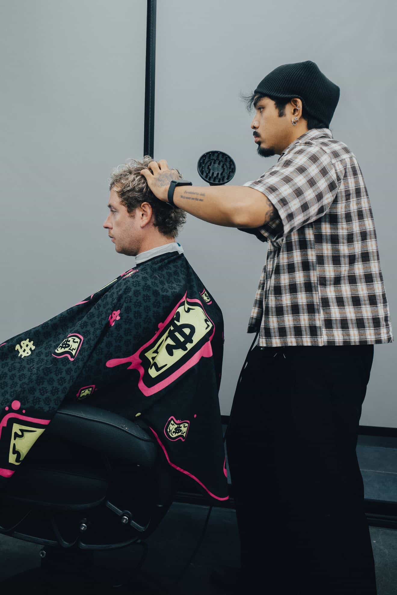 Tiger — barber at Fijii Cuts Bangkok giving a haircut
